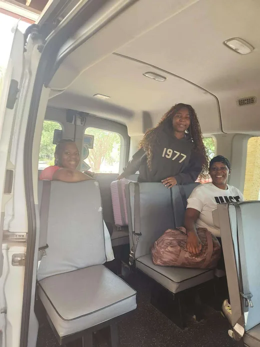 Three riders and their luggage settled inside the Tally Express van.